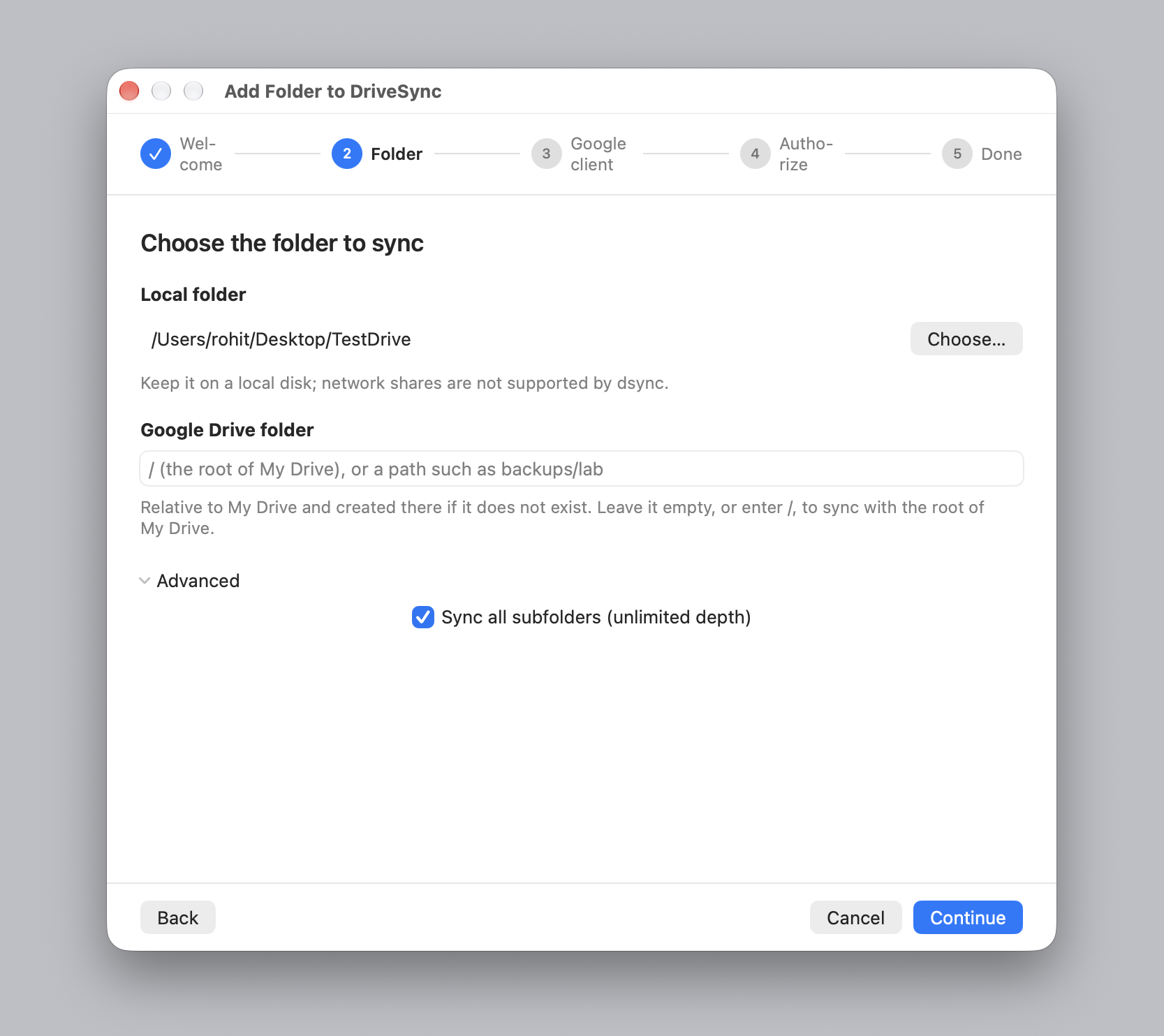 Step two of the wizard: a local folder path, an empty Google Drive folder field, and an Advanced section with sync all subfolders ticked.